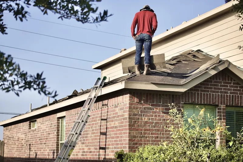 Professional roofer working on a residential roof in Belle Vista